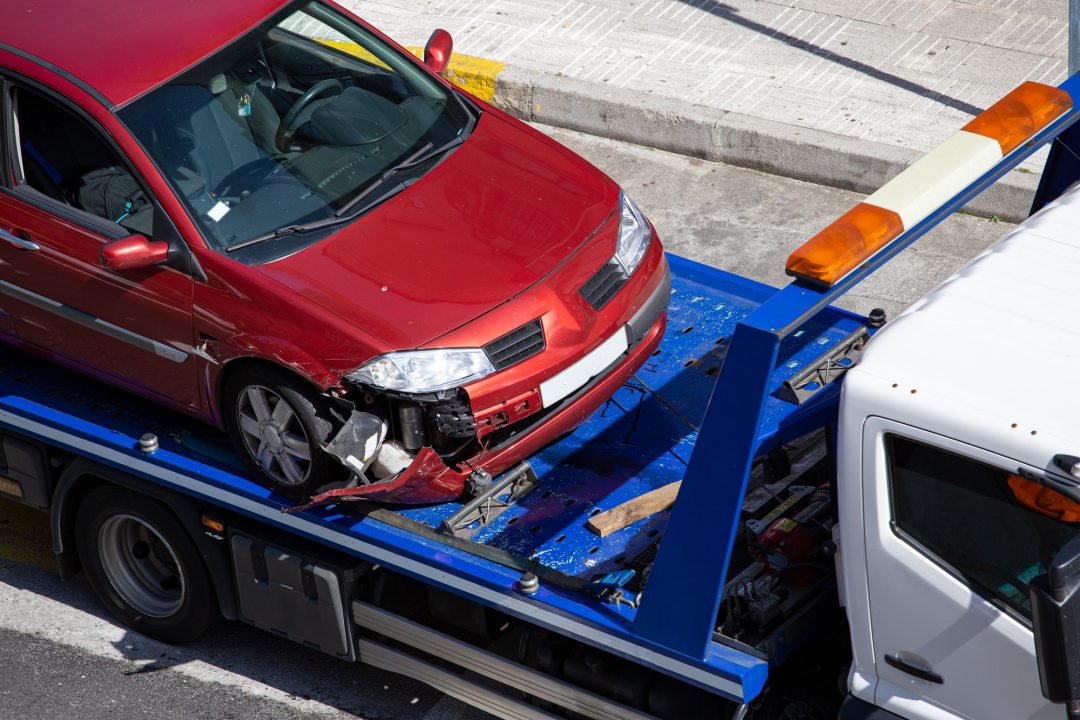 crashed car loaded on a tow truck