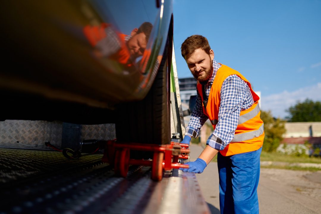 tow-truck-operator-fixing-the-car-on-platform.jpg